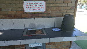 Sausages cooking on a BBQ, at Redcliffe Lagoon