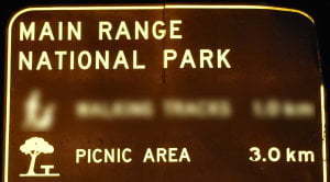 Brown sign for Main Range National Park Picnic Area, 3km, symbol for picnic area