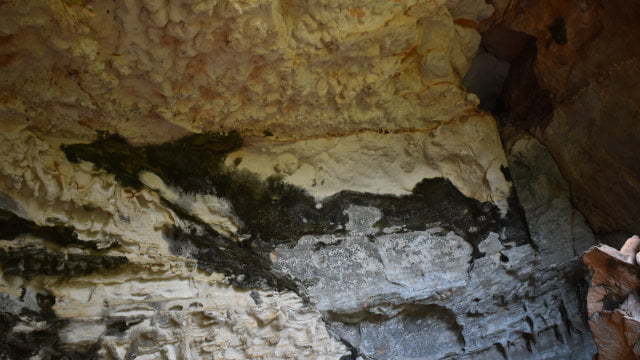 Back wall of a cave with a dark shape of a dragon, at the Dragon Cave at Cania Gorge