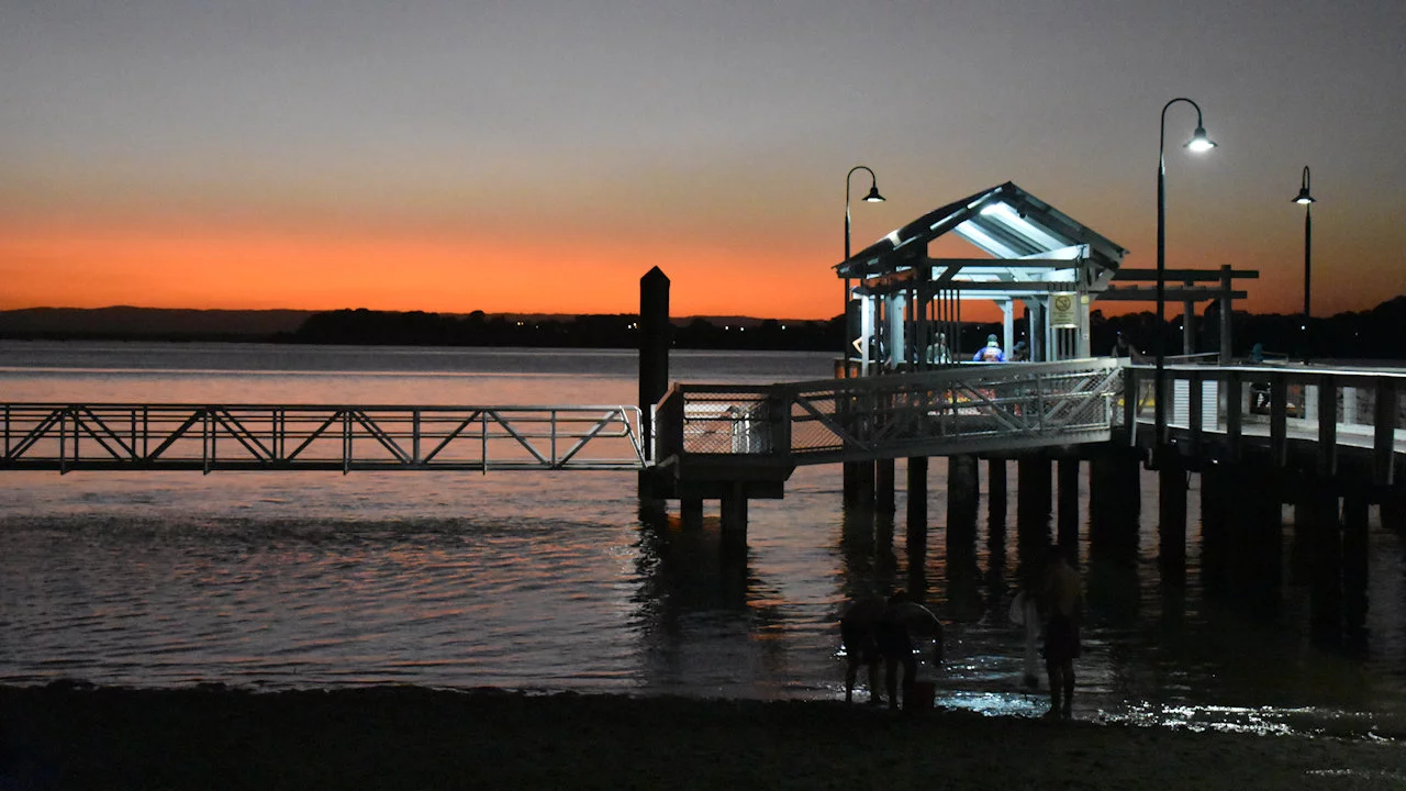 Bongaree Jetty on Bribie Island with the glow of a late sunset over Pumicestone Passage