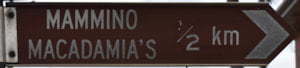 Brown sign for Mammino Macadamia's, 1/2 km