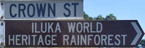 Brown sign for Iluka World Heritage Rainforest, white sign for Crown St