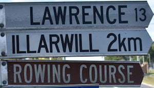 Brown sign for Rowing Course, white sign for lawrence (13km) and Illarwill (2km)