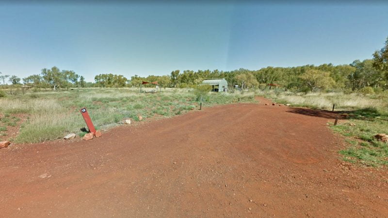 Miliyanha Campground site with toilets and picnic table behind