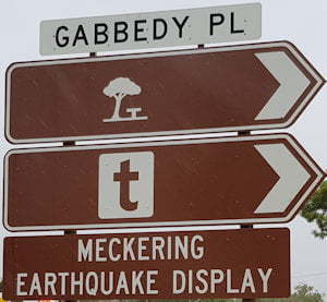 Brown sign for Meckering Earthquake Display, brown sign with a picnic symbol, white sign for Gabbedy Pl