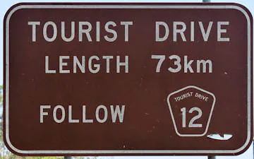 Brown sign for Fraser Coast Tourist Drive 12, length 73km