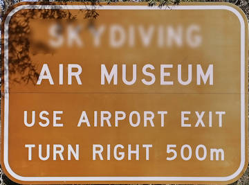 Brown sign for Air Museum, use airport exit, turn right 500m